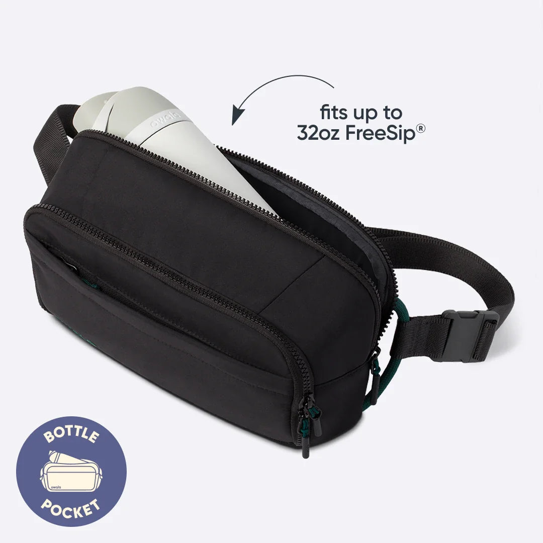 Owala All-Day Crossbody in Midnight Snack, black ripstop body with white Owala bottle stowed in the main compartment, with text reading "fits up to 32oz FreeSip" and a "BOTTLE POCKET" badge