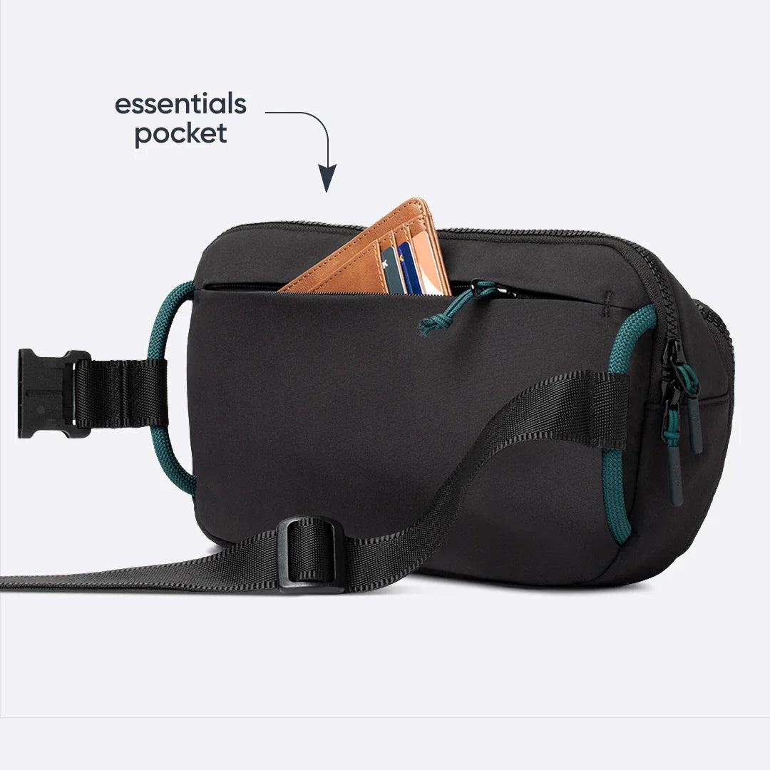 Owala All-Day Crossbody in Midnight Snack, black ripstop body with a brown leather wallet sticking out of the back pocket, with text reading "essentials pocket"